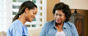 Happy care giver with elderly woman